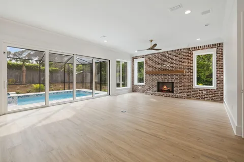 a view of an empty room with glass door and windows