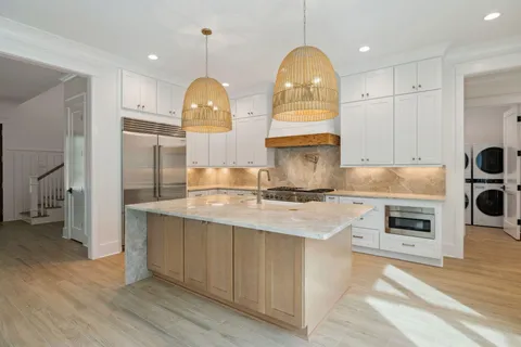 a kitchen with a sink a stove and cabinets