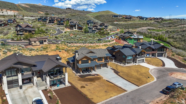 10646 North Reflection Ridge Hideout, UT 84036 - Photo 40 of 43 Contemporary mountain-style architecture featuring multiple pitched roofs, extensive window placements, stone accents, and integrated garages