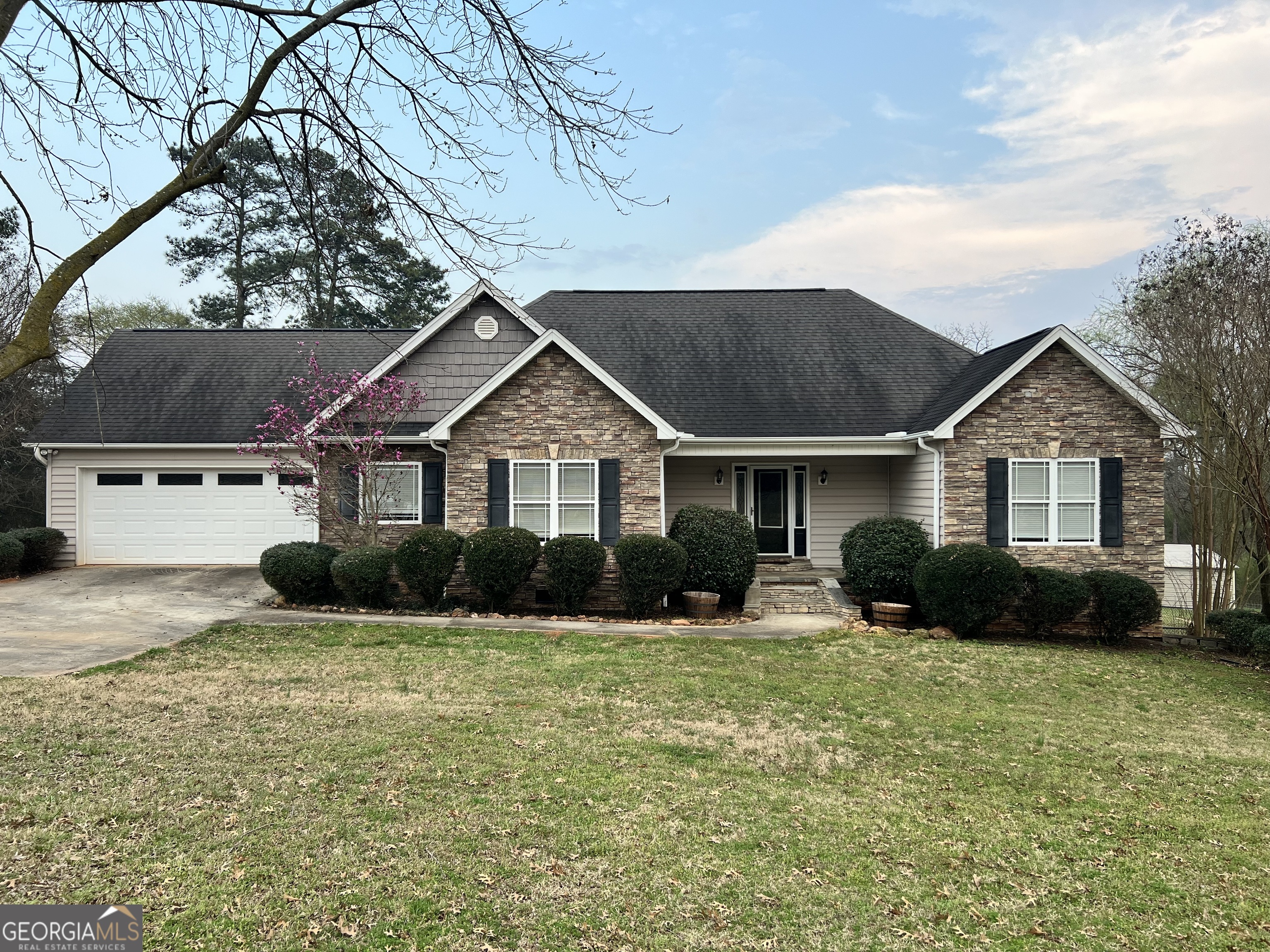 1211 Parham Town Road Bowman, GA 30624 - Photo 1 of 63 a front view of a house with a yard and garage