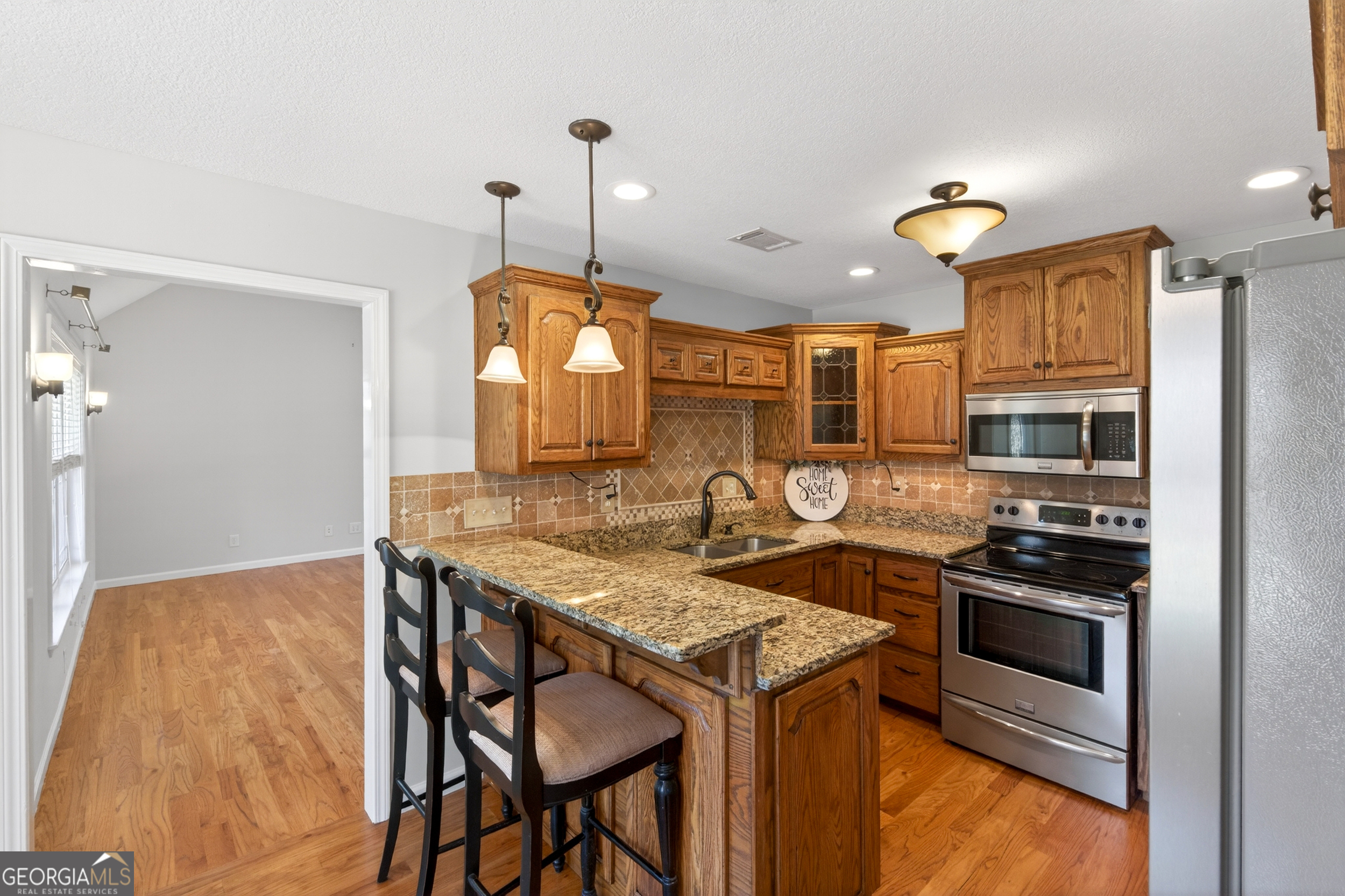 1211 Parham Town Road Bowman, GA 30624 - Photo 24 of 86 a kitchen with a stove a sink and a refrigerator