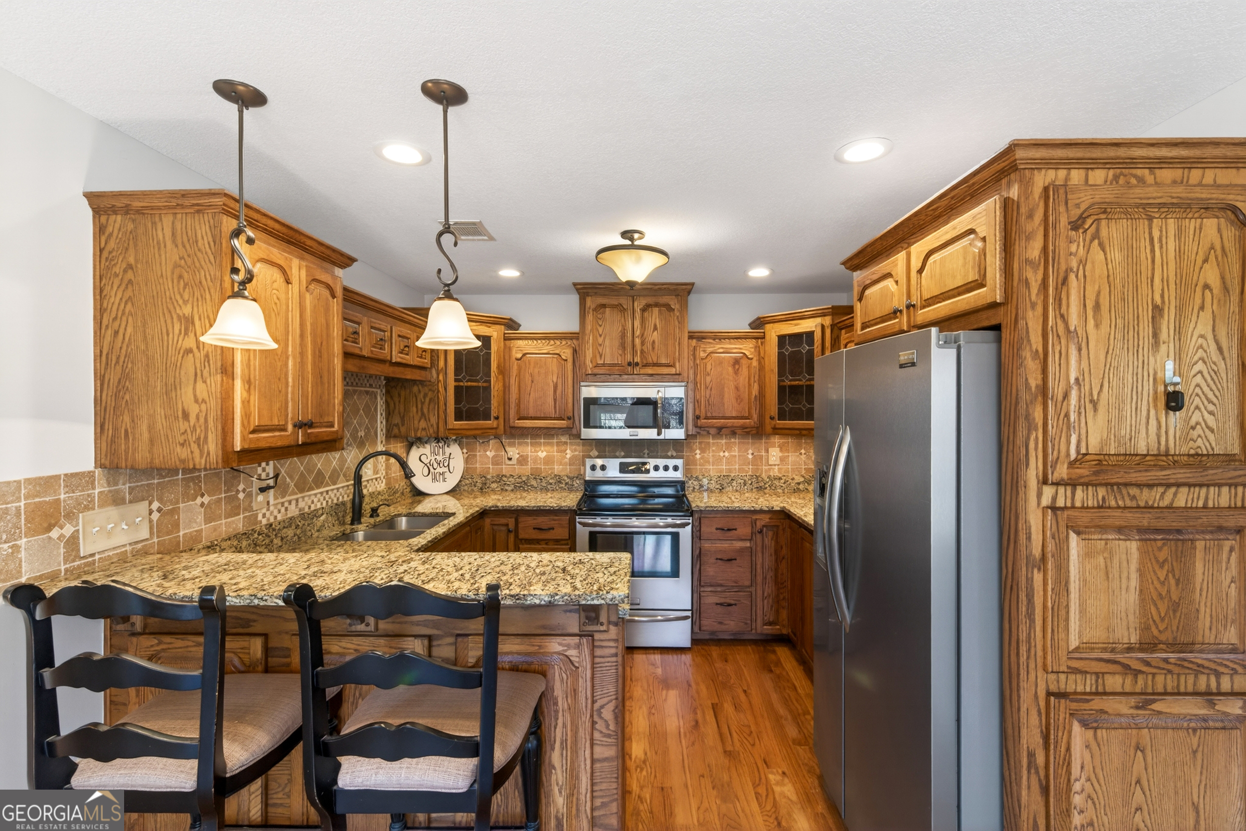 1211 Parham Town Road Bowman, GA 30624 - Photo 25 of 86 a kitchen with kitchen island a counter top space appliances and cabinets