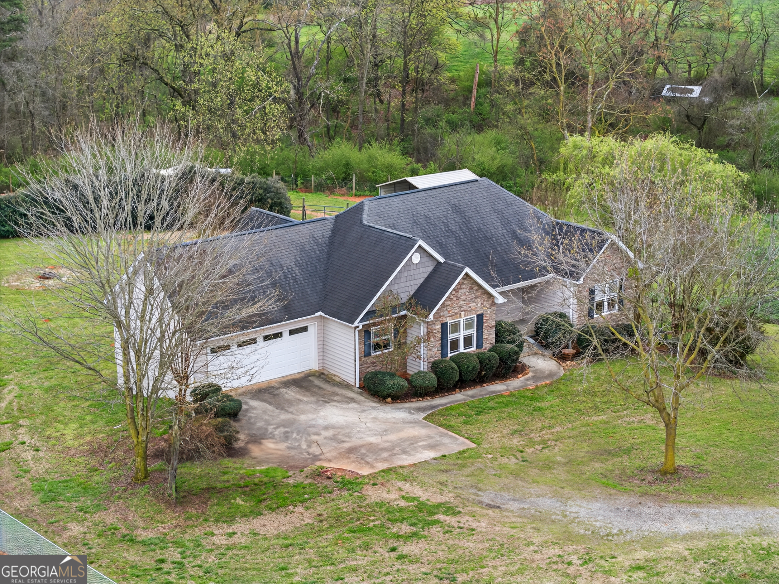 1211 Parham Town Road Bowman, GA 30624 - Photo 59 of 86 a aerial view of a house next to a big yard and large trees