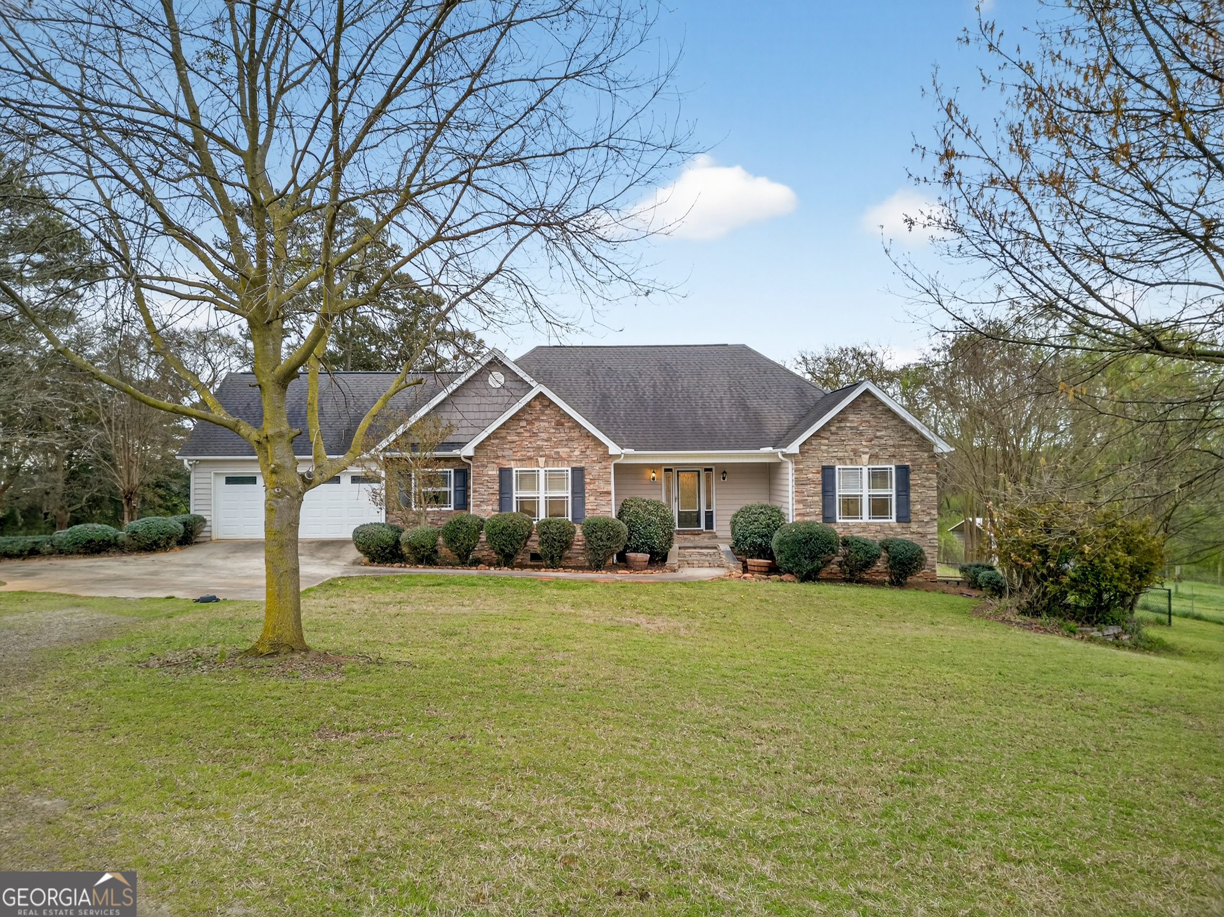 1211 Parham Town Road Bowman, GA 30624 - Photo 6 of 86 a front view of a house with a yard