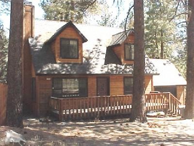 1774 Linnet Road Wrightwood, CA 92397 - Photo 1 of 1 a view of a brick house next to a yard