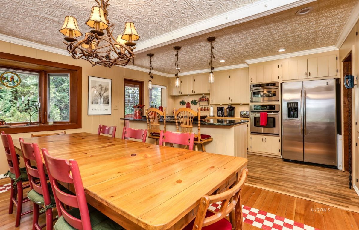 25891 Wayne Road Idyllwild, CA 92549 - Photo 21 of 72 a room with stainless steel appliances kitchen island granite countertop a table chairs in it and wooden floors