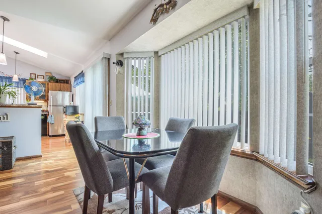 a view of a dining room with furniture and wooden floor