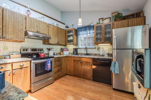 a kitchen with stainless steel appliances a refrigerator sink and cabinets