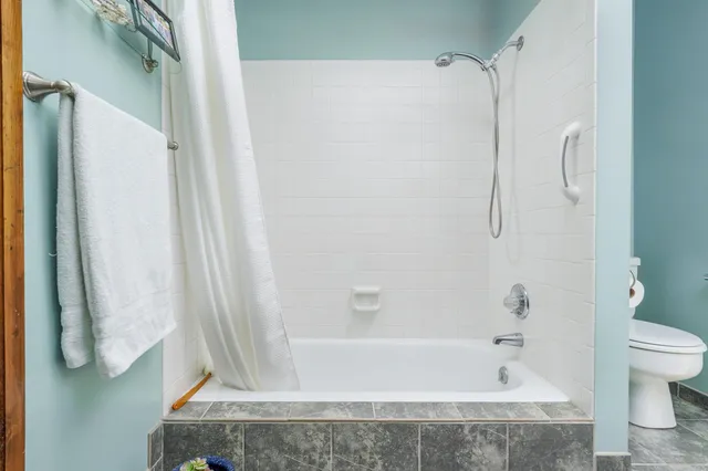 a bathroom with a bathtub and a shower