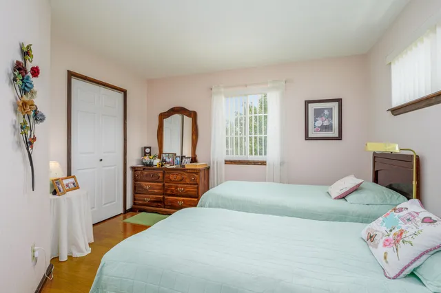 a bedroom with a bed and a dresser