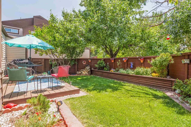 a view of a backyard with sitting area