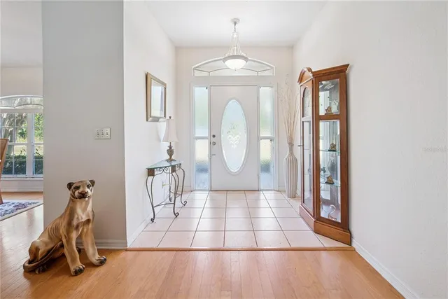 a living room with furniture a flat screen tv and a large window