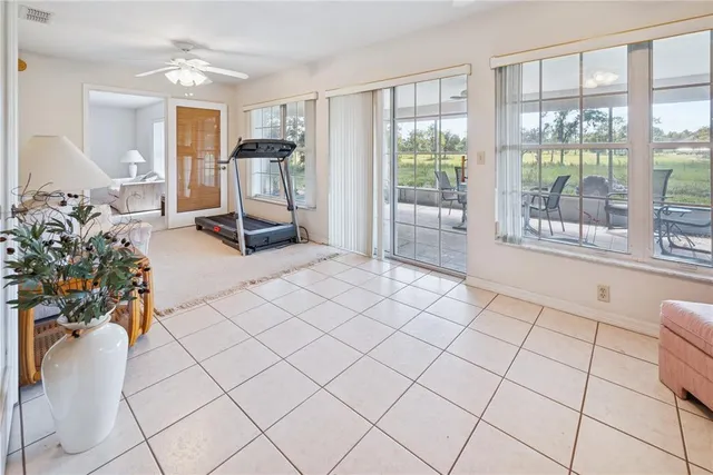 a living room with furniture a flat screen tv and a large window