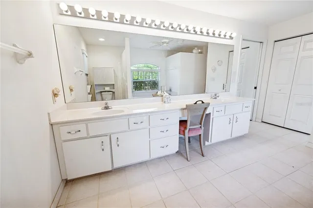 a spacious bathroom with a tub sink and mirror