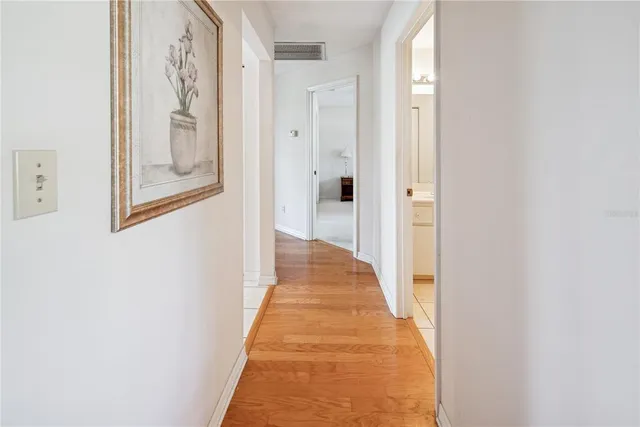 a living room with furniture a piano and a bookshelf