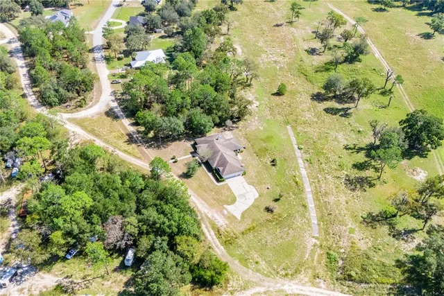 an aerial view of residential house with an outdoor space