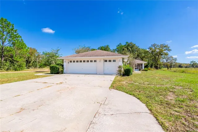 a front view of a building with a garden