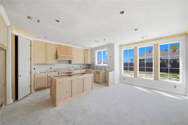 a view of a kitchen with refrigerator stove microwave and cabinets