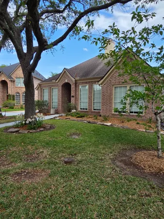 a front view of house with yard and green space