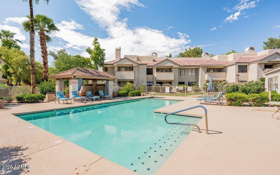 6885 East Cochise Road, Unit 142 Paradise Valley, AZ 85253 - Photo 47 of 47 a swimming pool with outdoor seating and yard