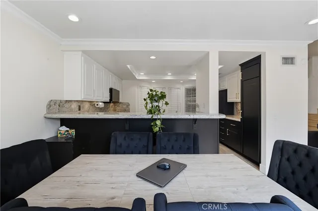 a kitchen with stainless steel appliances granite countertop a stove top oven a sink dishwasher and a microwave oven with cabinets