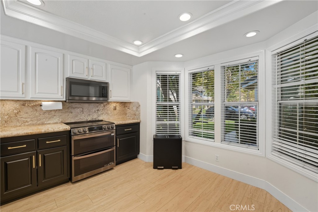 6070 East Summit Court Anaheim Hills, CA 92807 - Photo 24 of 60 a kitchen with stainless steel appliances granite countertop a stove and a sink
