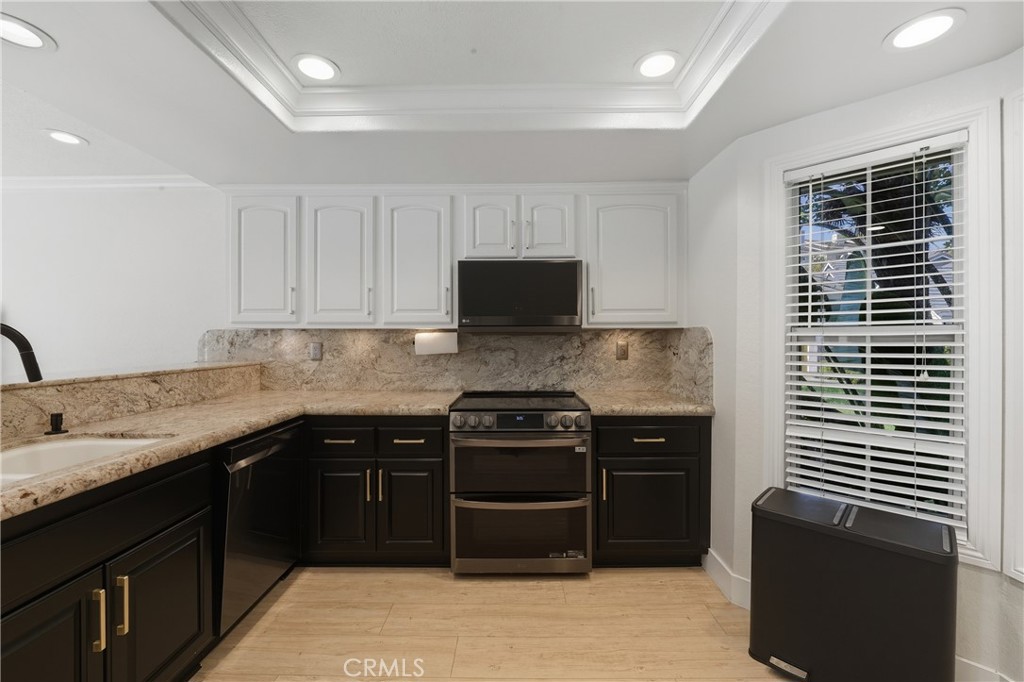 6070 East Summit Court Anaheim Hills, CA 92807 - Photo 25 of 60 a kitchen with a sink and a stove top oven