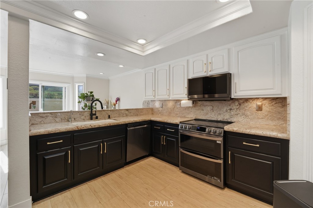 6070 East Summit Court Anaheim Hills, CA 92807 - Photo 26 of 60 a kitchen with stainless steel appliances granite countertop a stove top oven a sink dishwasher and a microwave oven with cabinets
