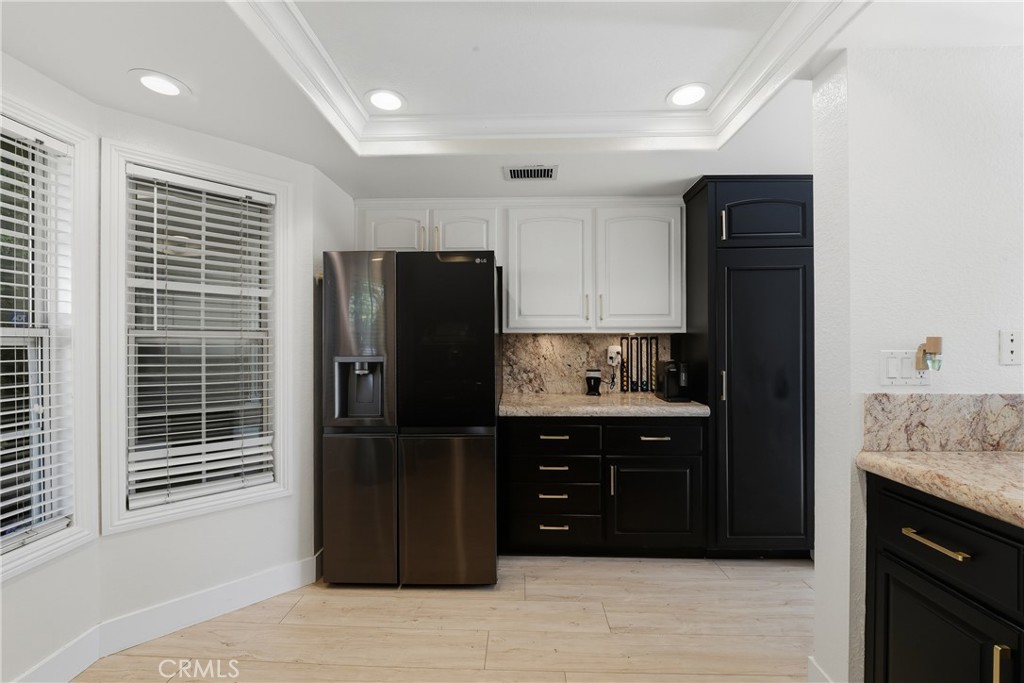6070 East Summit Court Anaheim Hills, CA 92807 - Photo 27 of 60 a kitchen with a refrigerator and cabinets