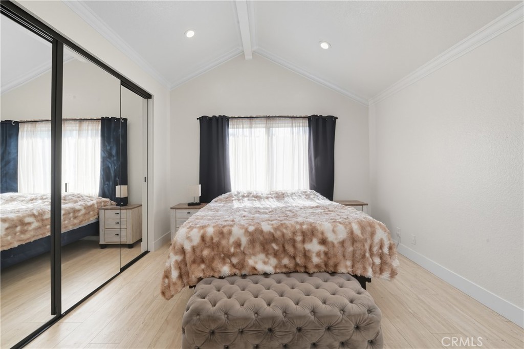 6070 East Summit Court Anaheim Hills, CA 92807 - Photo 39 of 60 a bedroom with a large bed and a chandelier