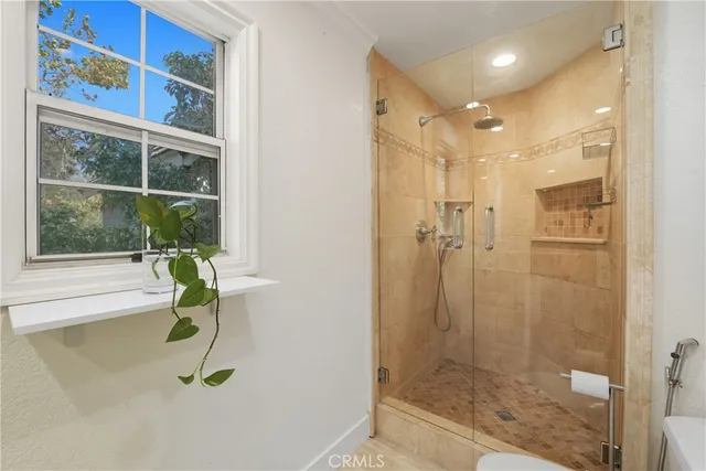 a spacious bathroom with a granite countertop sink a toilet and shower