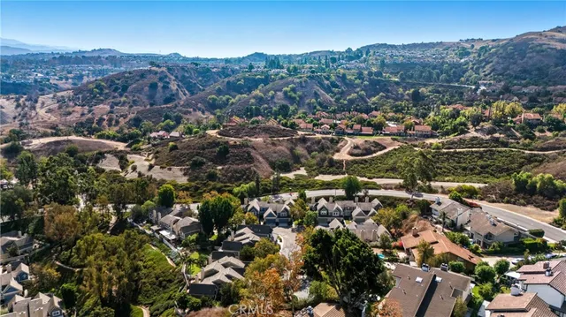 an aerial view of residential houses with outdoor space and street view