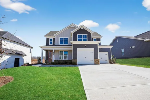 a front view of a house with a yard and garage
