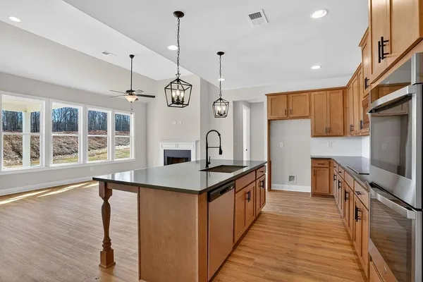 a view of a room with a fireplace wooden floor and windows