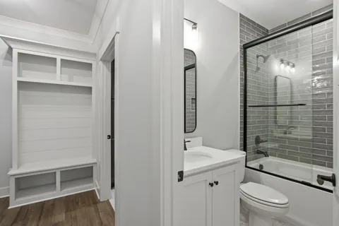 a bathroom with a shower a sink a toilet and shower