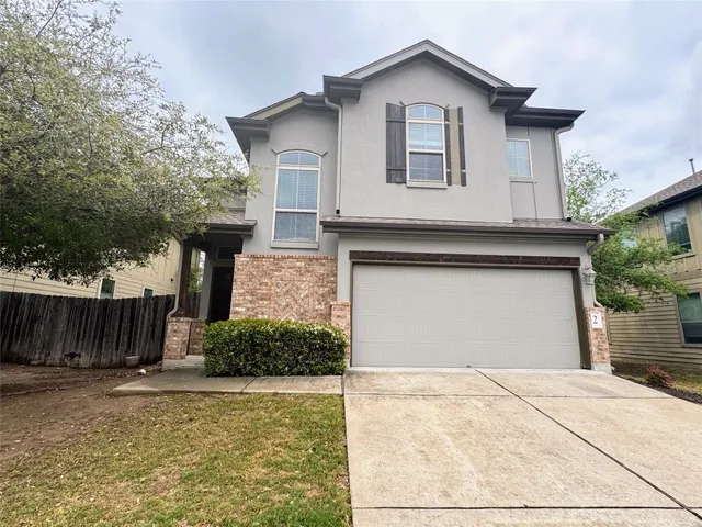 a view of white house with a yard and large tree