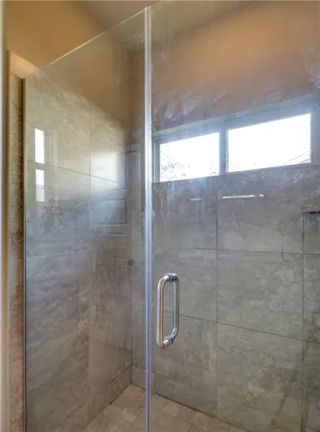 a bathroom with a glass shower door