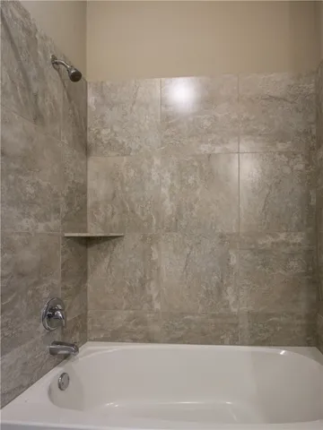 a bathroom with a shower and a sink