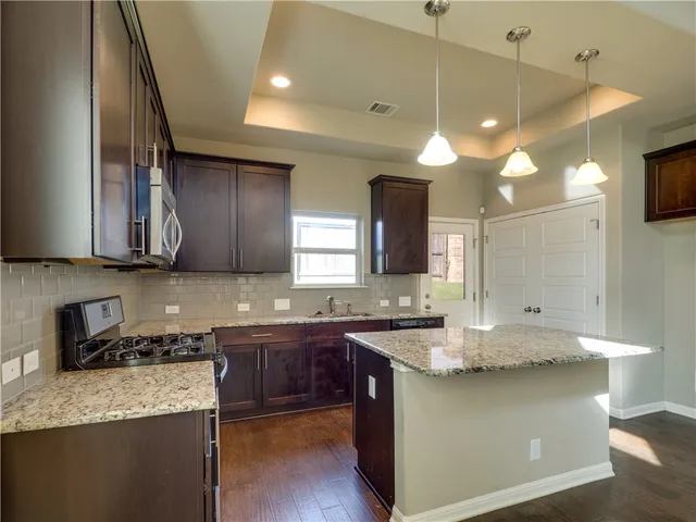 a kitchen with lots of counter space and sink