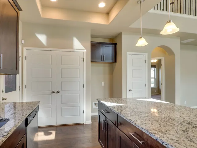 a bathroom with a granite countertop sink a toilet and large mirror