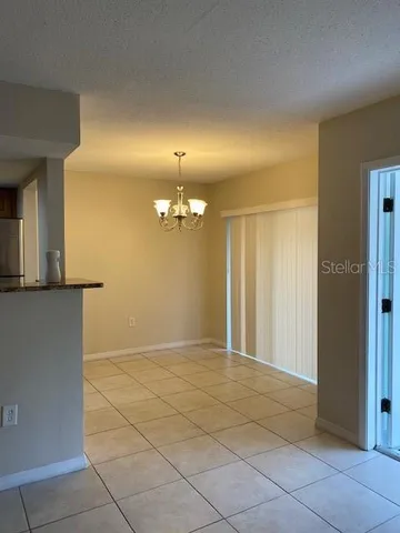 an empty room with kitchen view