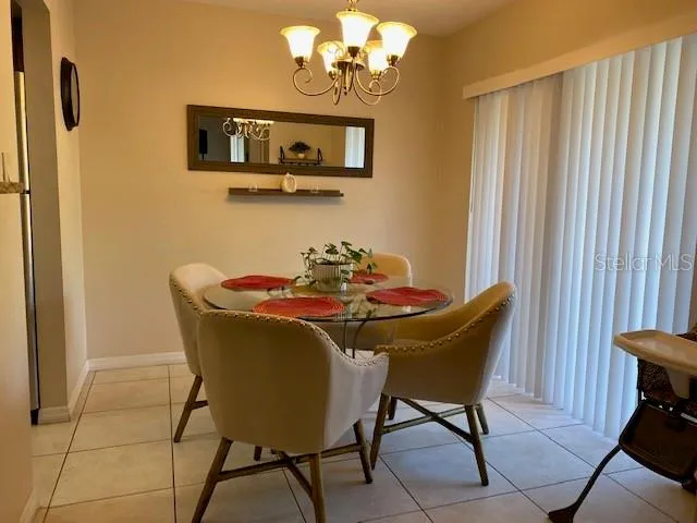 a view of a dining room with furniture and chandelier