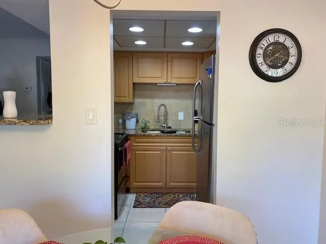 a kitchen with a refrigerator and a stove