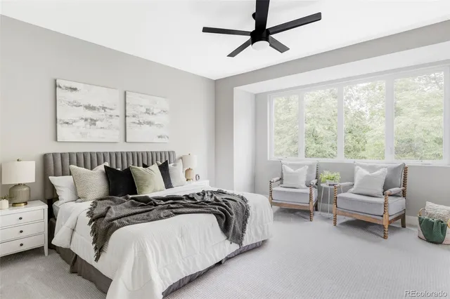 a bedroom with bed and large window