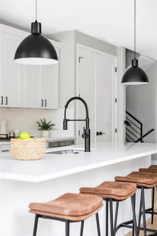 a kitchen with a sink a stove and a refrigerator