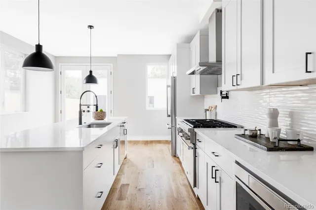a kitchen with stainless steel appliances a stove sink and cabinets