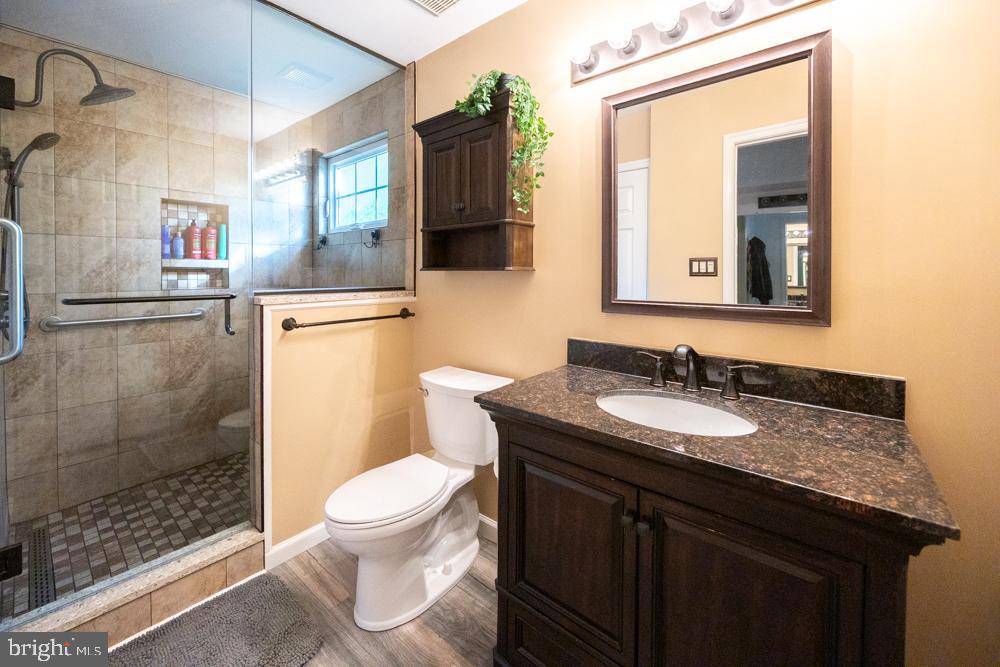 15 Timber Court Glassboro, NJ 08028 - Photo 21 of 32 a bathroom with a granite countertop sink toilet a mirror and shower
