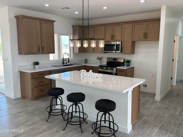a kitchen with cabinets a sink a counter space stainless steel appliances and cabinets