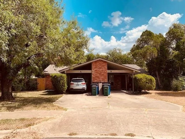 a view of a house with a yard covered in snow