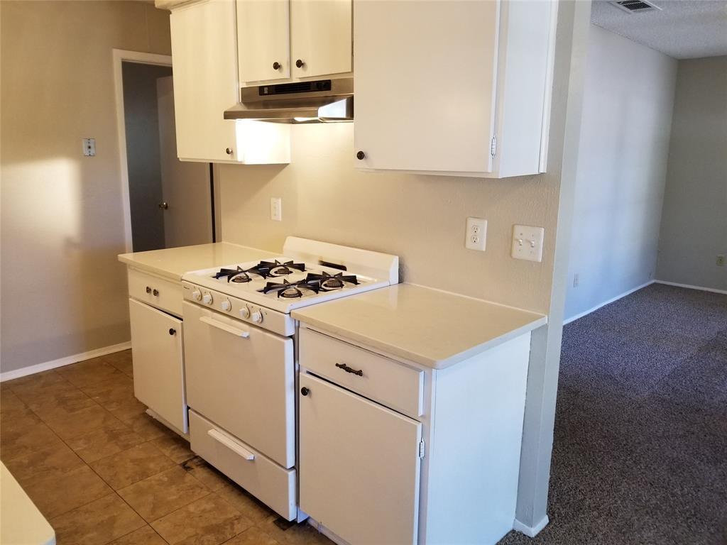5301 Indio Circle Austin, TX 78745 - Photo 12 of 16 a white stove top oven sitting inside of a kitchen